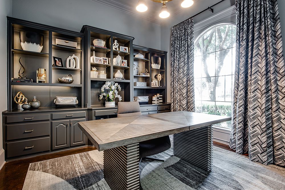 Custom cabinetry with beautiful lighting feature in this home office design.