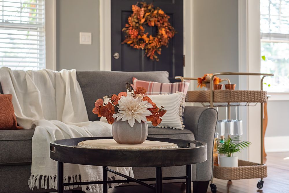 Cozy fall living room inspiration with warm throws and autumn pillows.