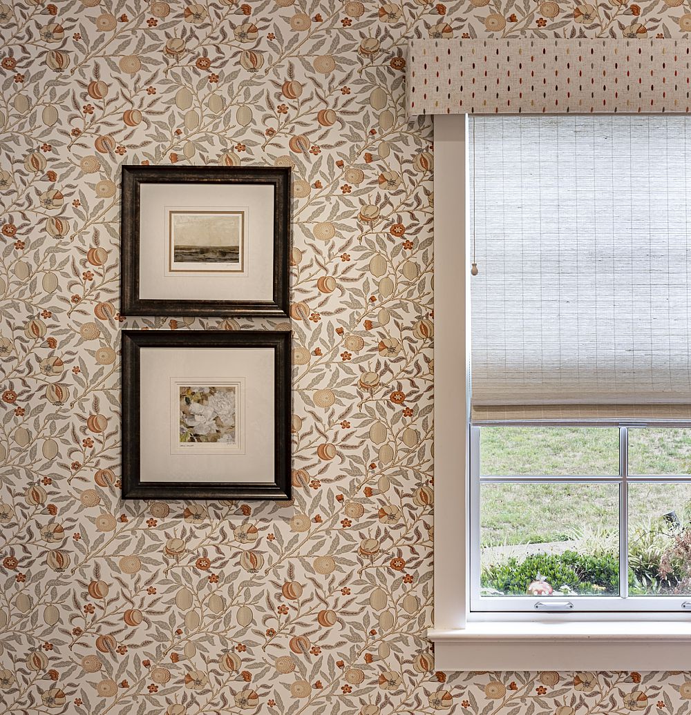 A traditional wallpaper pairs well with the modern fabric selected for the cornice board.